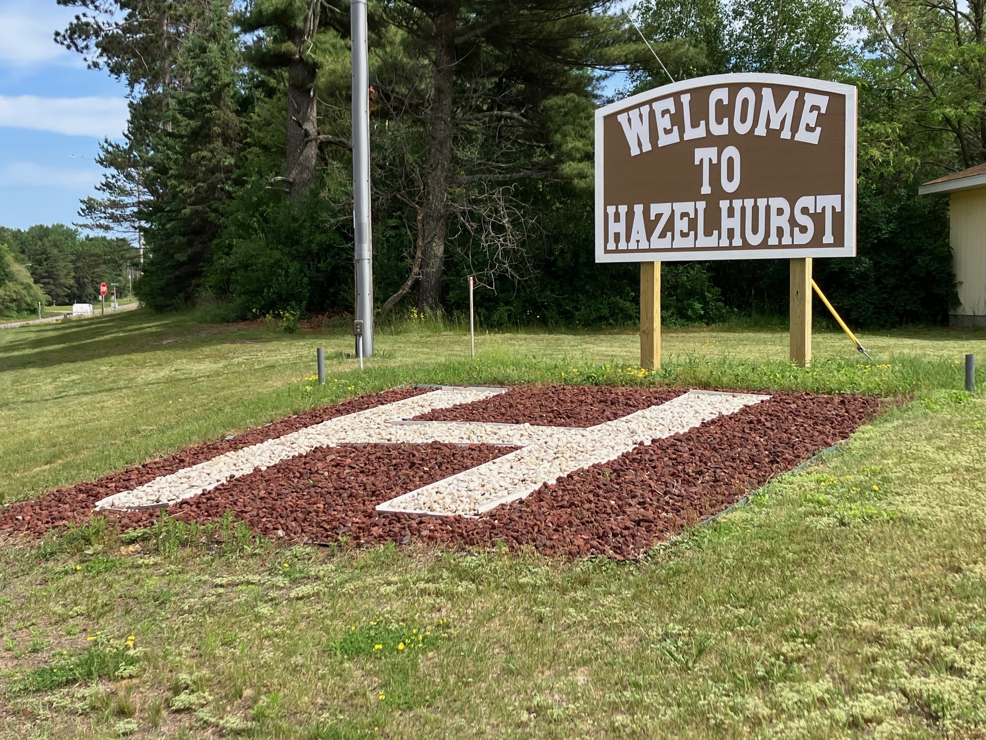 A wooden welcome sign for Hazelhurst, Wisconsin — The Quiet Side of the Northwoods