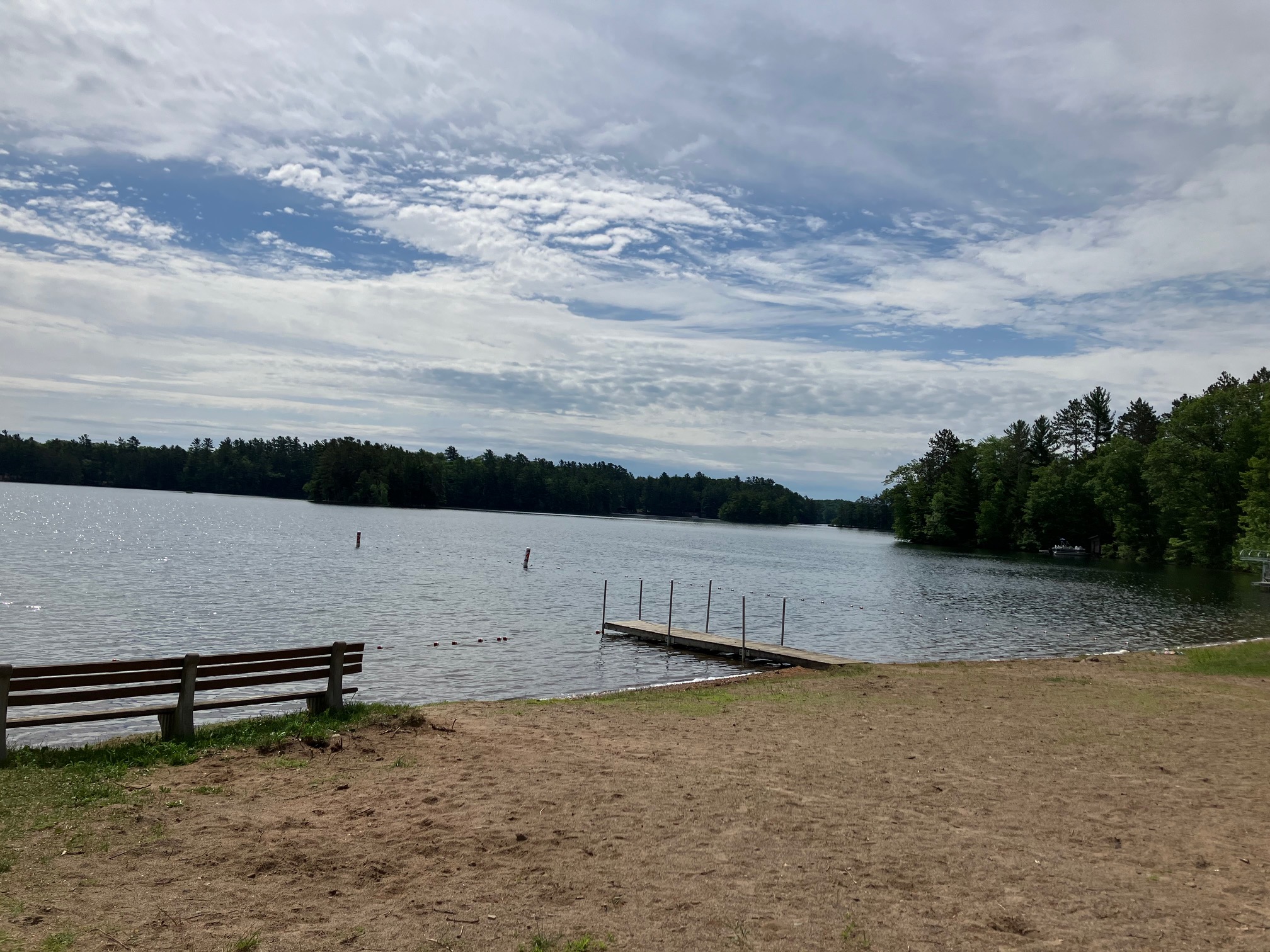 Beach and dock area on a sunny Northwoods afternoon